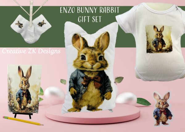 Enzo Bunny Rabbit Ultimate Gift Set by Creative ZK Designs, featuring a soft white onesie with Enzo illustration, fluffy Enzo-themed pillow, adorable Enzo socks, Enzo notebook, and a sticker print of Enzo Bunny Rabbit in a bowtie. Set presented on a pastel display with 'Creative ZK Designs' branding.