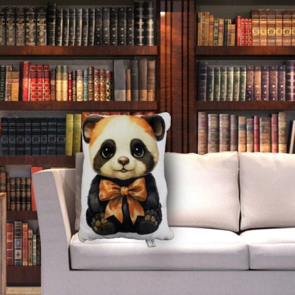 small muffin panda plush pillow on couch in front of a huge book shelf